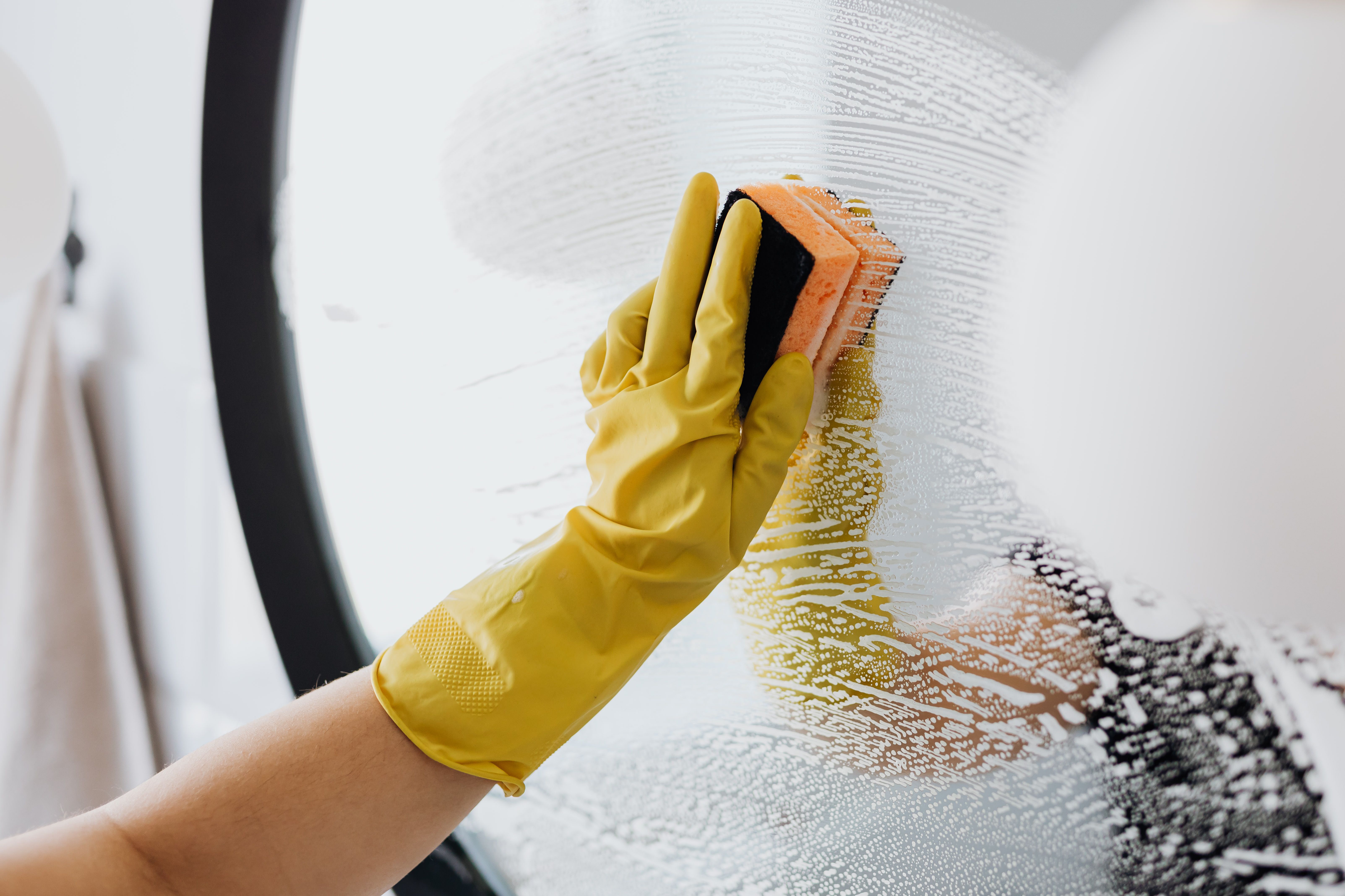 Steam mop gliding across a white hexagon tile bathroom floor